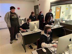 Student groups edit audio at computer stations